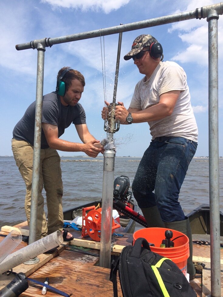 Justin and Zach collecting a piston core in the sediments of Joppa Flats.